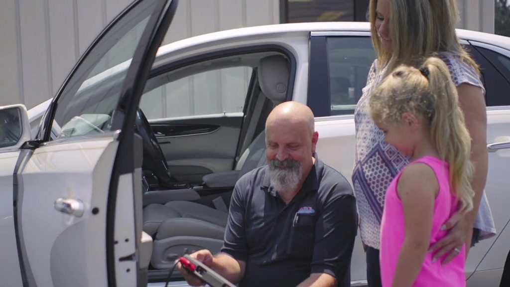 An employee speaking with customers at ACE Transmission in Springfield, Missouri.
