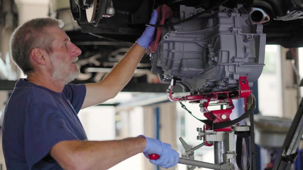 An employee installing a remanufactured transmission at ACE in Springfield MO.