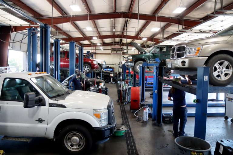 Lots of vehicles inside ACE Transmission repair shop in Springfield MO.